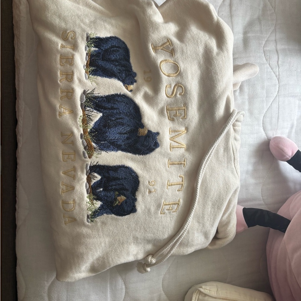 Brandy Melville Cream Hoodie with Blue Bear Design